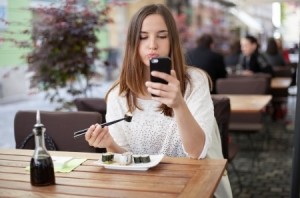Woman eating while reading text