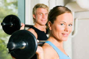 Couple holding barbells